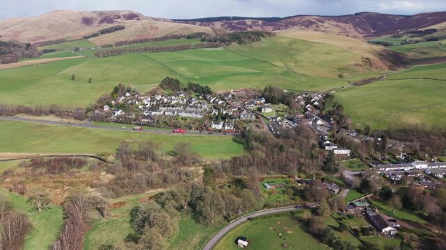 Cinematic view of the picturesque village of Eddleston showcasing Scottish architecture and scenic valley landscape.