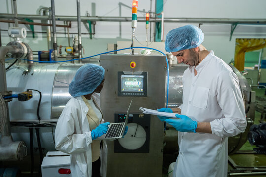 Quality assurance process in food industry factory technical meeting controlled environment close-up view collaboration