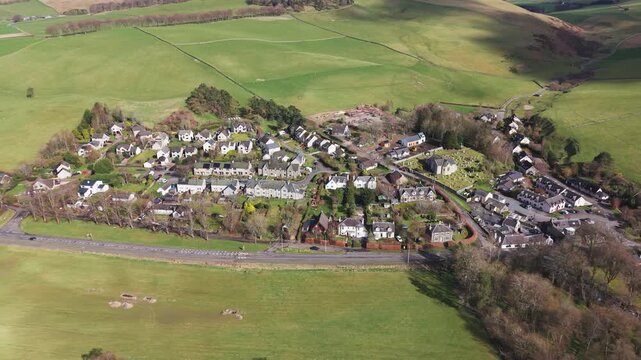 Drone flyover of the historic village of Eddleston in the Scottish Borders featuring traditional stone cottages and scenic countryside views