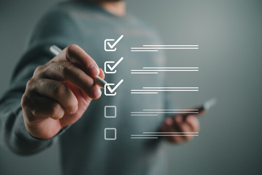 Businessman completing checklist on virtual interface, task management and workflow process concept, project planning, quality control, productivity tracking and business efficiency improvement
