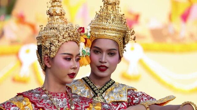 Two Thai Khon Dancers Perform Traditional Classical Dance in Ornate Gold Costumes