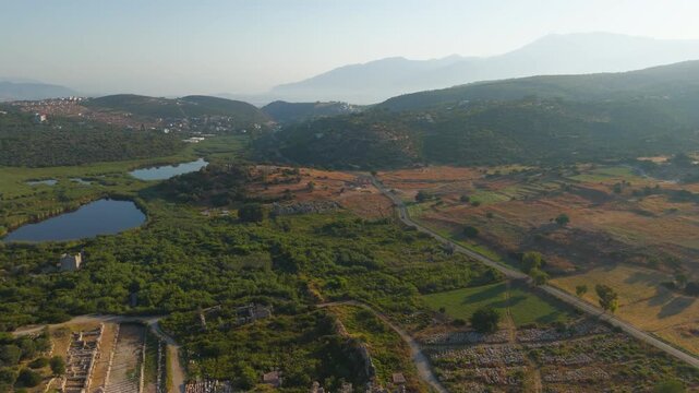Gelemis, Turkey. Ancient gate, modern roadway and Hurmalik Hamami thermal complex at Tepecik in Patara, historical and contemporary elements. Aerial View