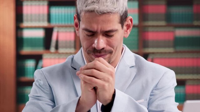 Lawyer Praying Thoughtfully At Desk