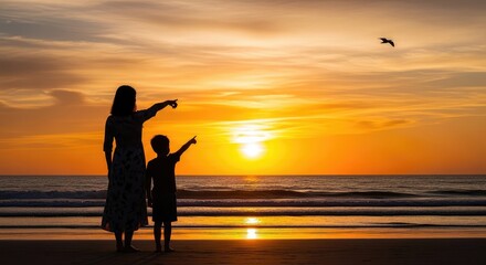 Fototapeta premium Silhouette of mother and son pointing at sunset over ocean mother's day background wallpaper poster banner download 2026 2027