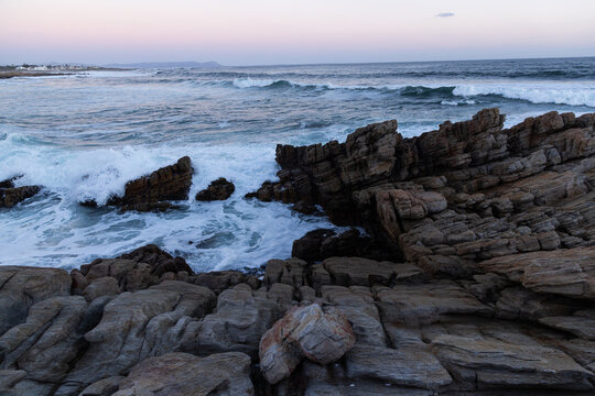 rocky coastline of Onrus, South Africa at dusk