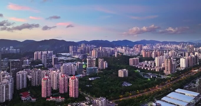 Aerial view of modern residential apartments and green city park at sunset in Shenzhen, China