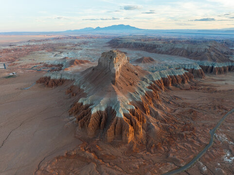 Aerial view of the unique rock formations and desert landscape of Goblin Valley State Park with distant mountains Green River, Utah, United States.