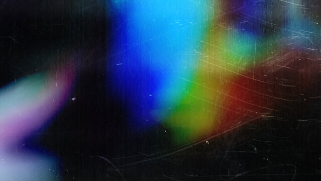 high res flash full frame macro photo of abstract scratched pastel iridescent holographic foil background with light leaks. holo color wrinkled material. cool glitter surface with shiny rainbow feel.