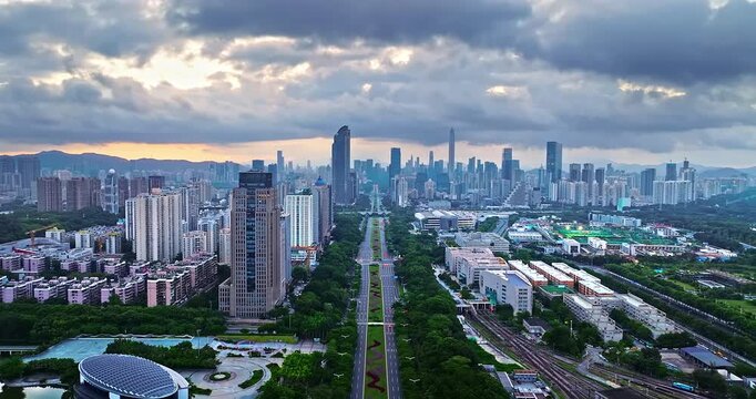 Aerial view of modern city skyline and financial district skyscrapers with urban green axis at dusk in Shenzhen, China