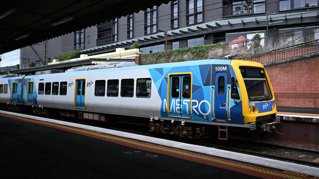 Side view of X'Trapolis train, operated by Metro Trains Melbourne, arriving at Malvern Railway Station during the day