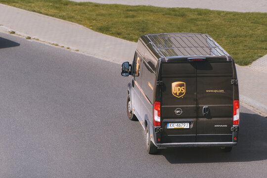 UPS United Parcel Service courier van driving past parked cars 29 08 2025 Poland Europe