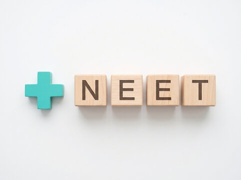 neet exam concept with wooden cubes and medical plus symbol on white background representing medical entrance preparation result and healthcare education concept