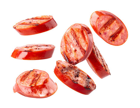 Falling grilled sausage slices isolated on white background, flying bratwurst pieces cutout for BBQ, cooking and food explosion compositing
