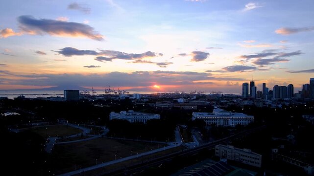 Aerial view overlooking capital city of Manila, Philippines during twilight sunset before night time darkness