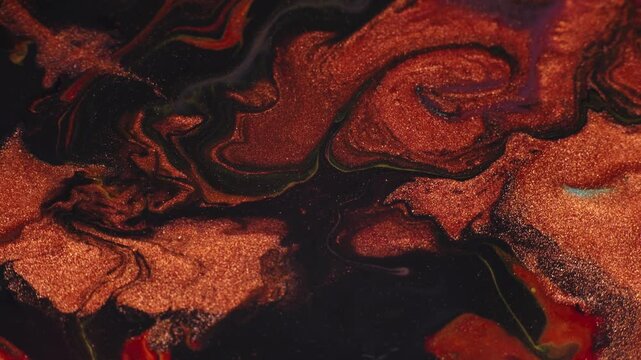 Shiny copper metallic paint on a black background. Fluid art acrylic pouring macro texture