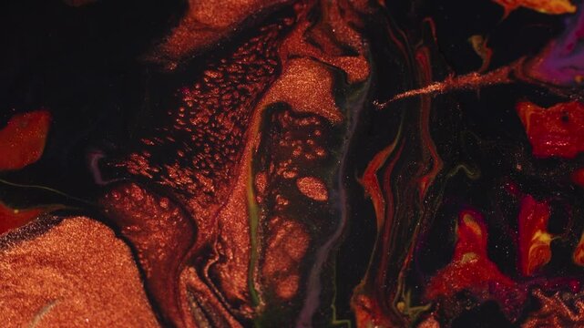 Copper orange and liquid black paint are mixed. Dark abstract background. Fluid art acrylic pouring macro texture