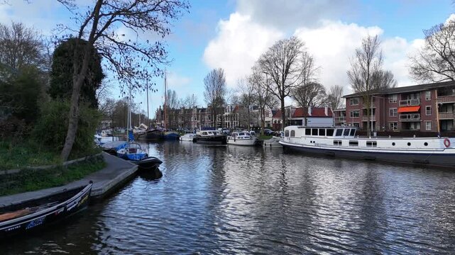 Curving drone turn around quiet canal corner and garden