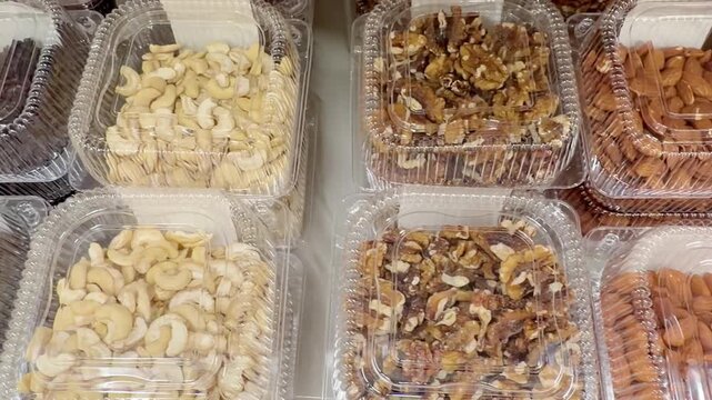 Choosing a variety of nuts at the supermarket