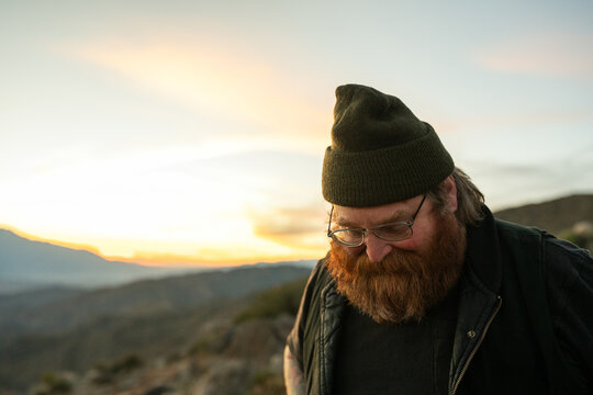 ginger man in beanie at keys view at sunset