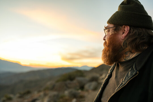 ginger man in beanie at keys view at sunset