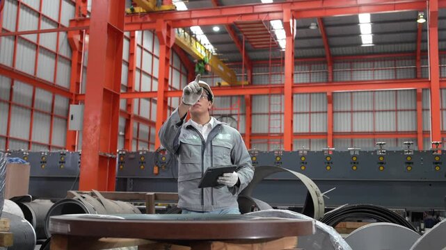 Worker operating machinery in industrial facility action shot inside factory technical environment close-up view