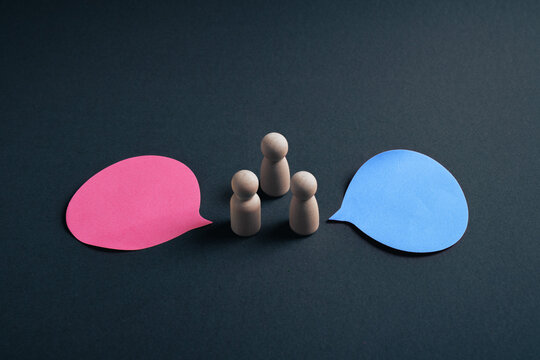 Business mediation and team communication concept with wooden figures between two speech bubbles