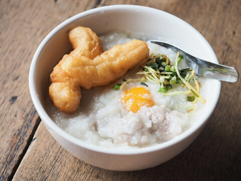 congee with deep fried Patongko bread stick dough, boiled egg, minced pork ball, fresh ginger and spring onion