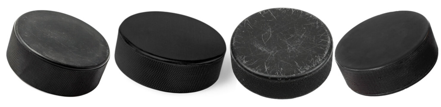 Multiple black ice hockey pucks showcasing various angles, isolated on a transparent background for sports design.