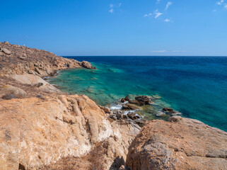 Obraz premium Panoramic view from the rocky shore of Mykonos island to the beautiful Aegean Sea in Greece.
