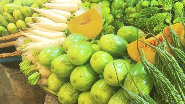 Fresh green lemons and sliced citrus fruits arranged together, highlighting natural freshness, healthy food concept, and vibrant tropical produce display