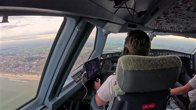 Cockpit view flying above Dutch tulip fields and coastline
