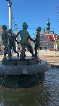 Children's fountain in Zwickau on the main market with cathedral in the background, Saxony East Germany vertical