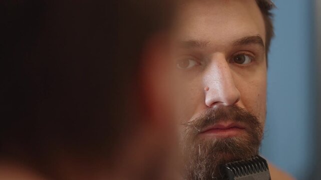 Man shaving beard using electric beard shaver(4k60p)