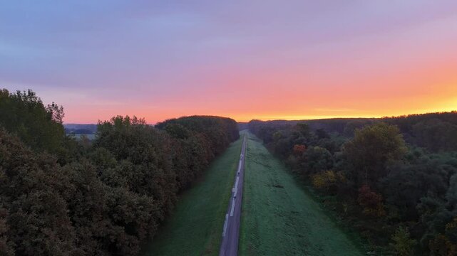 Aerial drone of red reddish sunrise sky over trees