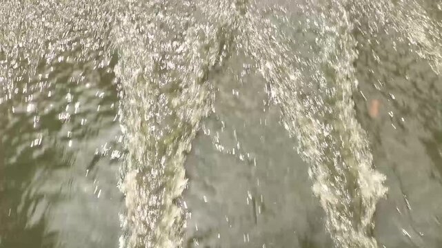 Dirty river water full of garbage. Muddy river water. Spring flood. Dirty muddy water with a whirlpool and white foam close-up