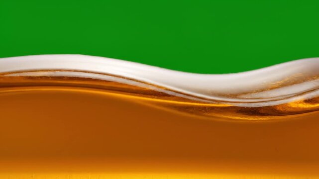 Macro Golden Liquid Wave Motion Swirling Against Green Screen Background