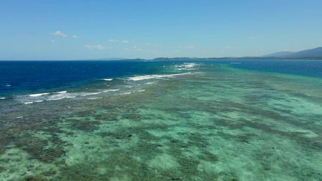 Montecristi coral reef with turquoise water and breaking waves, aerial view showing ocean nature and coastal beauty.