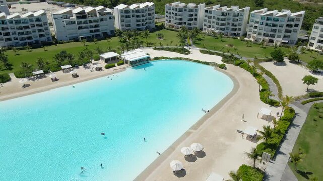 Aerial view of a modern apartment complex in punta cana, dominican republic, featuring a large man-made crystal lagoon.