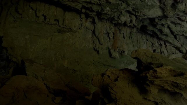 Panning across the interior of Xieng Liap cave to the second entrance of the system with a small sandbar extending into the water.