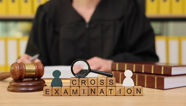 In a bustling courtroom, a judge prepared for a cross examination writes notes while a gavel and documents symbolize the weight of justice and truth in the air.