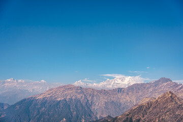 A serene mountain landscape with clear blue sky Tungnath temple, Uttarakhand, india © 3 Travelers
