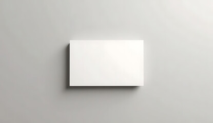 Naklejka premium A blank white card on a plain gray background for design or branding purposes
