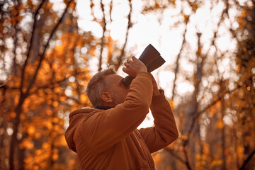 Fototapeta premium Amateur birdwatcher observing birds and other animals in nature with binoculars.