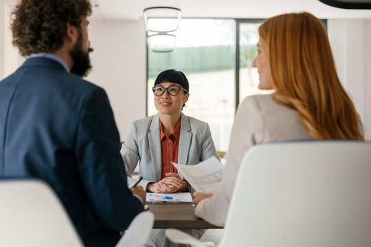 Businesswoman interviewed by experts in a modern office