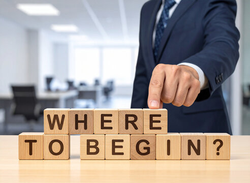 Where to begin? - Geschäftsmann zeigt auf den Text "Where to begin?"