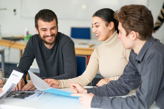 students of different nationalities, sitting at desks, 