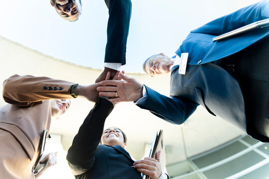 Business team uniting hands for motivation and success