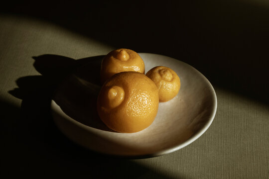 Preserved lemon on plate in warm light with shadow