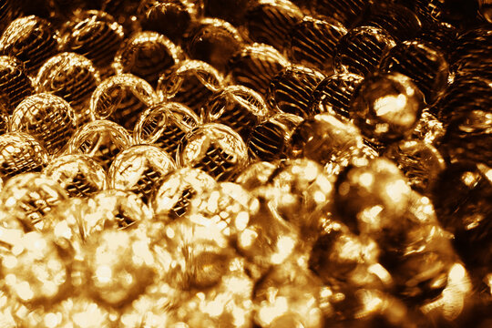 Abstract closeup of shiny spherical bubbles as golden background