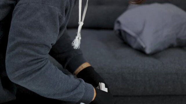 Criminal in Black Gloves Stealing Cash and Loot from a Living Room
